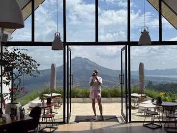 Дружина з моїм поларойдом SX-70 у модній балійській кавʼярні з видом на гору Батур. Прямо у цій кавʼярні затвор камери заклинило, й до кінця поїздки фотографувати на поларойд вже не було можливості :(